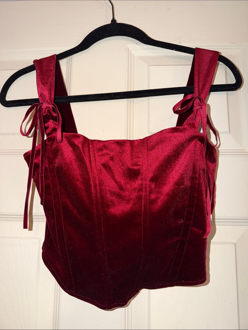 Red velvet corset top with ties on the straps